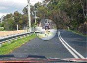 Traffic Lights Lanes - When the road is marked this way are you permitted to cross the lines to overtake the bicycle rider if the way forward is clear?